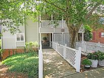 Inviting walkway leading to a condo with a beautiful porch and well-maintained landscaping at 403 Gooseneck Dr # A-1, Cary, NC 27513