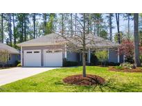 Charming home with a well-manicured lawn and two-car garage offering a welcoming curb appeal at 4331 Millcreek Cir, Pittsboro, NC 27312