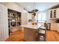 Bright white kitchen featuring a pantry, marble countertops and island with seating at 4331 Millcreek Cir, Pittsboro, NC 27312