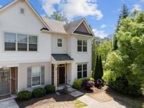 Two-story townhome with light siding, landscaping, and a welcoming front door at 7851 Allscott Way, Raleigh, NC 27612