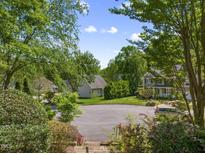 A lush residential neighborhood with sidewalks, mature trees, and well-maintained homes creating a peaceful atmosphere at 102 Treadwell Ct, Cary, NC 27513