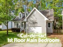 Charming gray home with a manicured lawn and attached one car garage in a cul-de-sac at 104 Silver Fox Ct, Cary, NC 27511