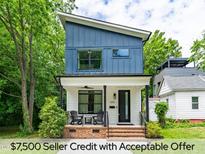 Charming two-story home featuring a modern exterior, covered porch, and well-manicured lawn at 1202 S Bloodworth St, Raleigh, NC 27601