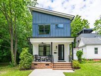 Modern two-story home features a charming front porch and blue and white siding at 1202 S Bloodworth St, Raleigh, NC 27601
