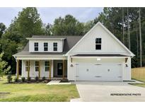 Charming two-story home featuring a covered front porch and a two-car garage at 200 Pretty Run Branch Ln, Wendell, NC 27591