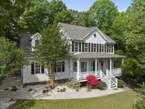 Charming two-story home with a welcoming front porch and beautiful landscaping at 204 Black Forest Dr, Clayton, NC 27527