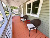 Inviting front porch featuring two wicker chairs and painted wood flooring at 2101 S Roxboro St, Durham, NC 27707