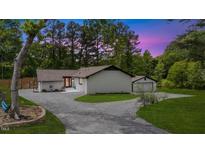 Charming single story home with fresh white paint and a gravel driveway at 226 Smith Dr, Durham, NC 27712