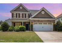 Charming two-story home with a well-manicured lawn and a two-car garage at 2437 Everstone Rd, Wake Forest, NC 27587