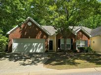 Charming brick home featuring an attached two-car garage and lush landscaping at 2565 Bent Green St, Raleigh, NC 27614