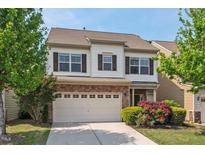 Charming two-story home featuring a brick-accented garage and well-maintained landscaping at 2728 Evanston Ave, Durham, NC 27703