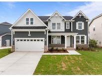 Charming two-story home featuring a two-car garage, manicured lawn, and a mix of gray siding and white trim at 3529 Bailey Lake Dr, Fuquay Varina, NC 27526