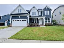 Charming two-story home with a beautifully landscaped front yard and a two car garage at 3529 Bailey Lake Dr, Fuquay Varina, NC 27526