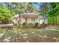 Charming single-story home with a welcoming front porch and well-maintained landscaping at 3607 Springhollow Ct, Efland, NC 27243