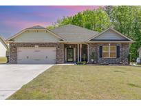 Charming brick home with a well-manicured lawn and an attached two-car garage at 49 Parkside Dr, Lillington, NC 27546