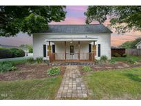 Charming home featuring a covered front porch with decorative wood railing at 510 May St, Gibsonville, NC 27249