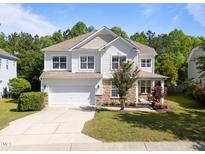 Charming two-story home with stone accents, attached two-car garage, and manicured landscaping at 5240 Holly Ridge Farm Rd, Raleigh, NC 27616