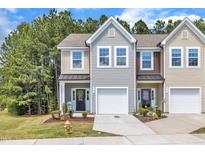 Charming townhome with a well-manicured lawn, attached garage, and inviting front entrance at 5701 Princess Curry Way, Raleigh, NC 27610