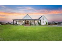 Stunning modern farmhouse with a large front yard, inviting porch, and charming architectural details at 6185 Nc-50, Benson, NC 27504