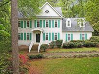 Charming two-story home with green shutters, a landscaped yard, and inviting front porch at 6245 Hampton Ridge Rd, Raleigh, NC 27603