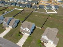 An aerial view displays the new construction homes with expansive lots in a Gathering-friendly neighborhood at 76 Arlie Ln, Lillington, NC 27546