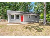 Charming single-story home with a bright red front door and gray siding at 804 Harper Rd, Hillsborough, NC 27278