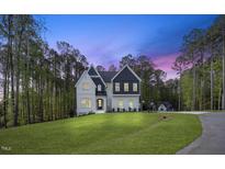 Beautiful exterior of a two-story home with a manicured lawn and mature trees at 8237 Baronleigh Ln, Wake Forest, NC 27587