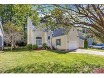 Charming home featuring a well-manicured lawn and inviting curb appeal, with mature trees at 8629 Swarthmore Dr, Raleigh, NC 27615