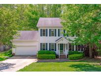 Charming two-story home with green shutters, landscaped yard, and attached two-car garage at 107 Candy Apple Ct, Cary, NC 27513