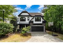 Charming two-story home with a stone-accented garage and well-manicured front yard at 1209 Shasta Daisy Dr, Wake Forest, NC 27587