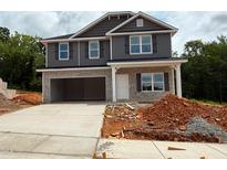 Charming two-story home featuring a stone and gray facade, a two-car garage and a concrete driveway at 127 High Hampton Way, Fuquay Varina, NC 27526