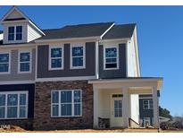 Charming townhome featuring stone accents, neutral siding and a welcoming front entrance at 1569 Wendell Valley Blvd, Wendell, NC 27591