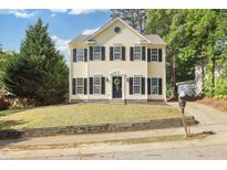Charming two-story home with a well-maintained front yard and classic architectural details at 1832 Elkpark Dr, Raleigh, NC 27610