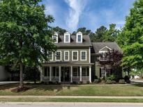 Charming two-story home with a front porch and a well-manicured lawn at 200 Larkhaven Pl, Apex, NC 27539