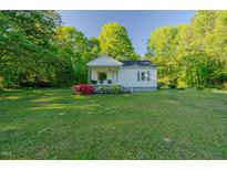Charming home with a well-manicured lawn, mature trees, and curb appeal at 2021 Bundy Ave, Durham, NC 27704