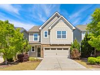 Charming two-story home featuring a two-car garage, stone accents, and manicured landscaping at 205 Begen St, Morrisville, NC 27560