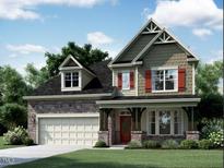 Charming two-story home with stone accents, red shutters and a welcoming front porch, perfect for suburban living at 2383 Picual Way # 24, New Hill, NC 27562
