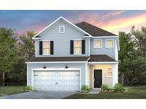 Charming two-story home with gray siding, a two-car garage, black shutters and beautiful landscaping at 3229 Pelican Ln, Durham, NC 27703