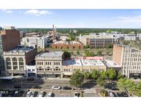 Exterior daytime view of commercial/residential building featuring the apartments, street, and parking at 323 W Main St # C, Durham, NC 27701