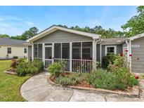 Charming home featuring a screened porch and manicured garden beds at 3902 Booker Ave, Durham, NC 27713