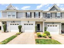 A charming townhouse with a one-car garage and well-manicured landscaping at 412 Stone Flower Ln, Raleigh, NC 27603
