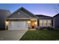 Charming single-Gathering home showcasing a stone-accented facade, inviting entryway, and well-maintained landscaping at 46 S Great White Way, Clayton, NC 27527