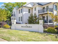 Elegant white brick sign reading 'The Woodburn' at a stylish, gated community entrance at 607 Smedes Place # B, Raleigh, NC 27605