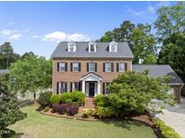 Charming two-story brick home with dormers and a beautifully landscaped front yard at 101 Conway Ct, Cary, NC 27513