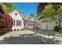 Charming home featuring a circular driveway and a three-car garage for ample parking and curb appeal at 108 Martinique Pl, Cary, NC 27511