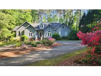 Charming home with mature landscaping, flowering bushes and a circular driveway at 113 Colonial Dr, Wendell, NC 27591