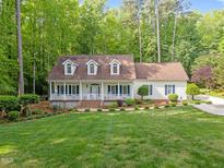 Charming single story home with a cozy front porch and well manicured lawn and landscaping at 1245 Torchlight Way, Raleigh, NC 27603