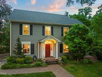 Charming two-story home with a red door, black shutters, and a well-manicured lawn at 1603 Hermitage Ct, Durham, NC 27707
