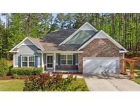 Charming single-Gathering home featuring a stone facade, attached two-car garage and welcoming front porch at 2005 Delphi Way, Wake Forest, NC 27587