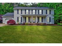 Charming two-story home with a well-manicured lawn and a welcoming front porch at 212 Ronaldsby Dr, Cary, NC 27511